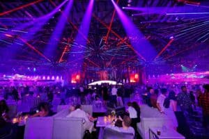 Vibrant corporate gala with dynamic lighting and guest engagement, captured by Christie’s Photographic Solutions.