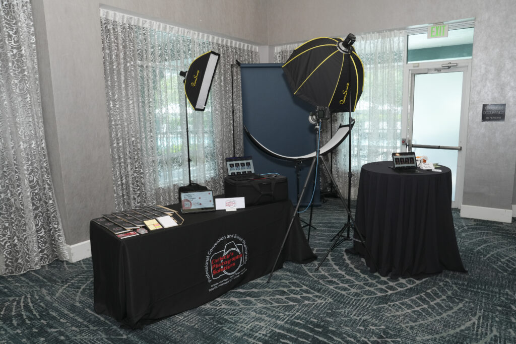 Professional on-site headshot photography station with branded setup and studio lighting, captured by Christie’s Photographic Solutions.
