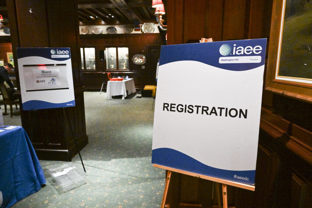 Registration signage directing attendees at event entrance, captured by Christie’s Photographic Solutions.