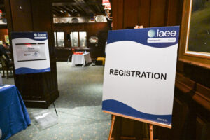 Registration signage directing attendees at event entrance, captured by Christie’s Photographic Solutions.