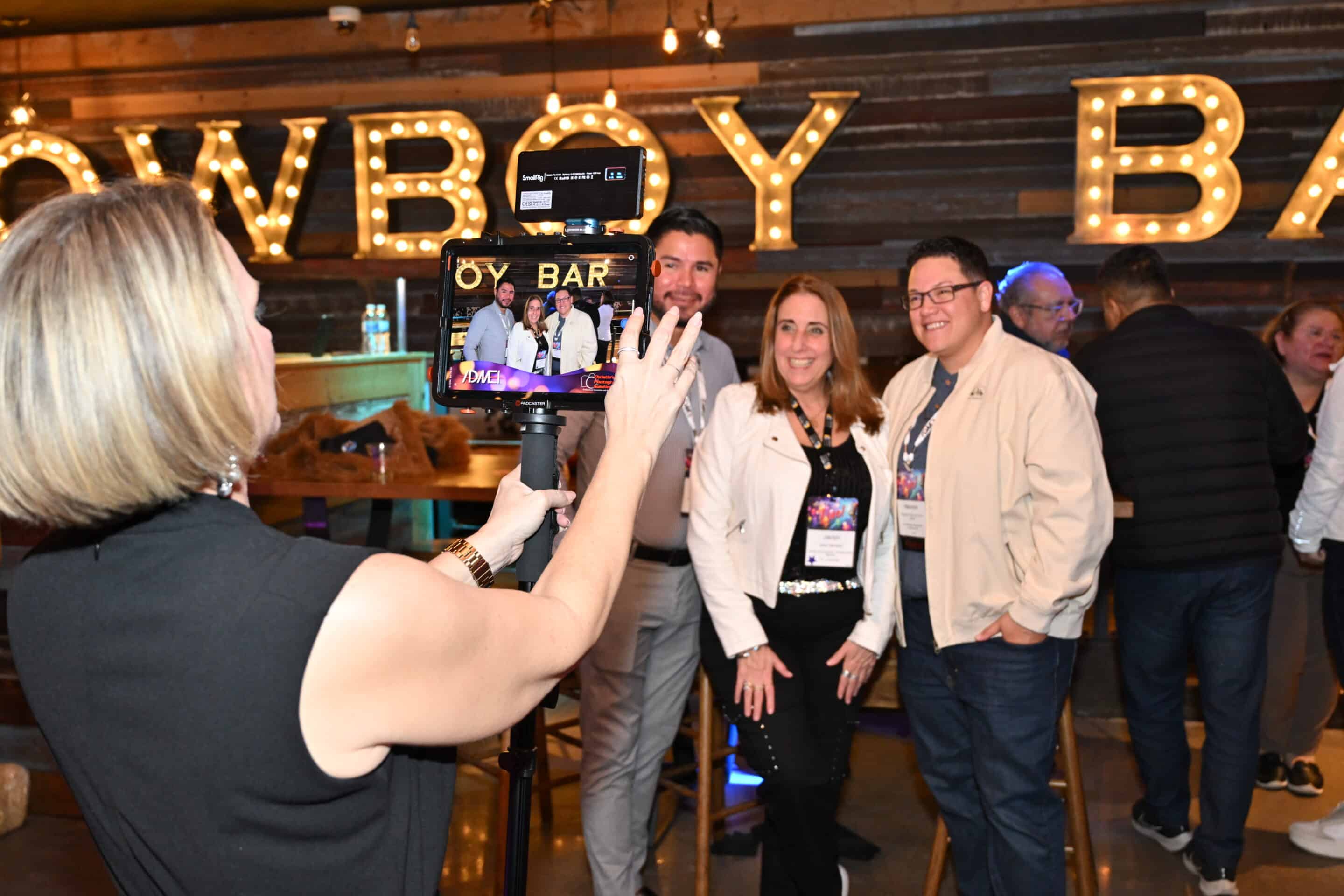 Event attendees pose for a photo during a lively networking social, captured by Christie’s Photographic Solutions.