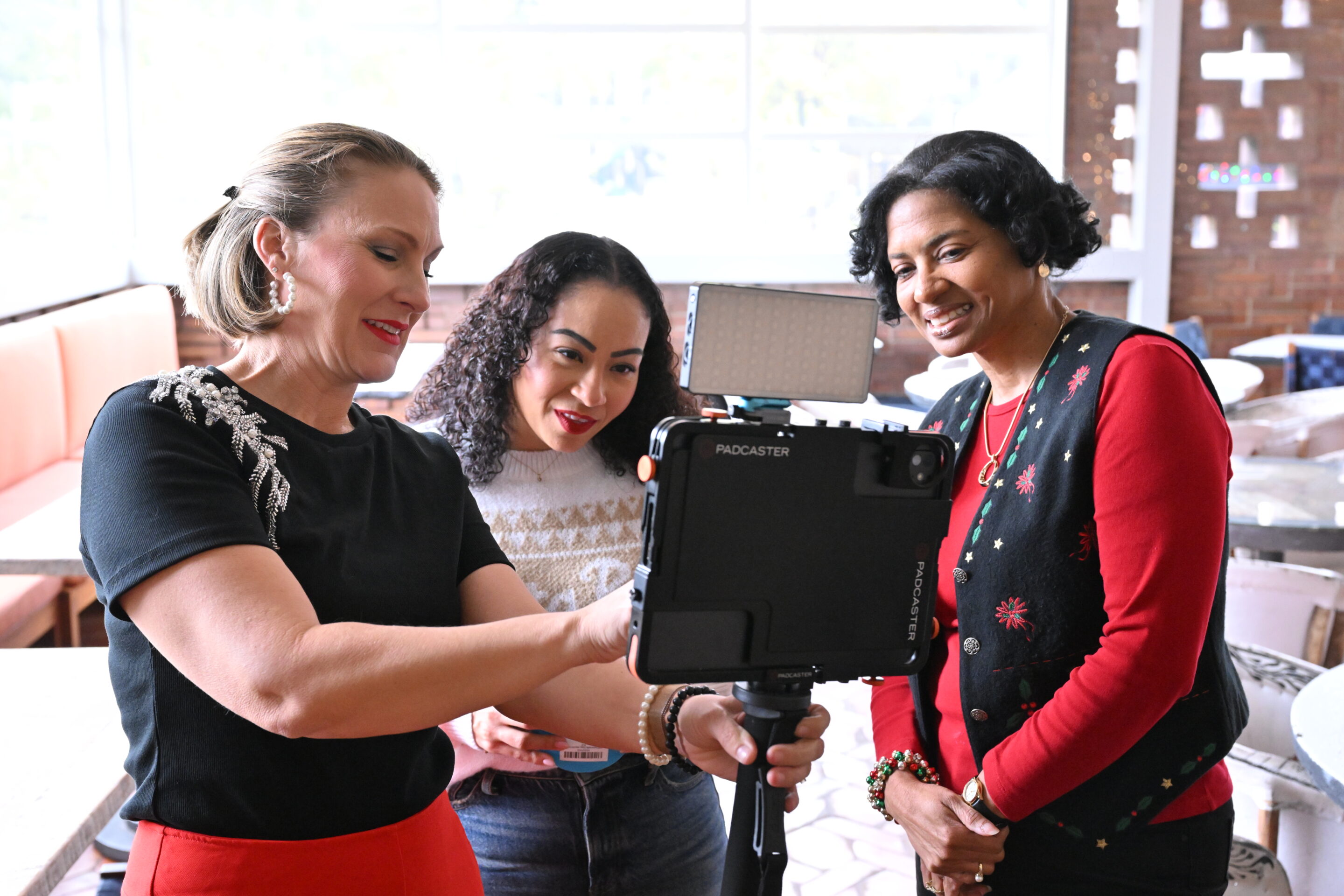 Attendees interacting with the iLite Roaming Photo Booth during a corporate event activation, captured by Christie’s Photographic Solutions.